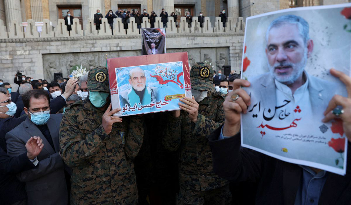 Members of Iranian forces carry the coffin of ambassador